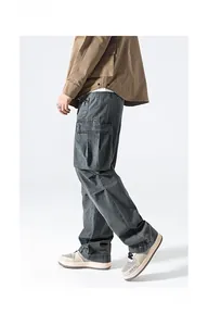 Detail shot of multi-pocket cargo pants showing side flap pocket and straight fit cut