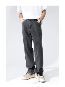 Detail of dark gray straight-leg denim jeans showing washed texture and vintage workwear style