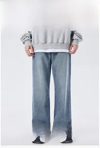 Detail view of light blue washed tapered jeans with high-street retro style and loose fit