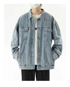 Detailed shot of loose-fit light blue vintage washed denim jacket with chest pockets