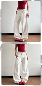 Detailed view of off-white wide-leg vintage denim jeans styled with sneakers