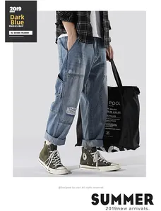 Detail of dark blue distressed jeans featuring washed finish and stylish torn accents