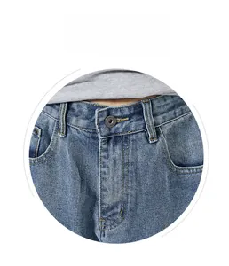 Detail view of denim jeans waist featuring metal button and high-quality washed fabric texture