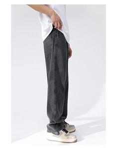 Detail view of washed dark grey straight-leg denim jeans with retro vintage finish