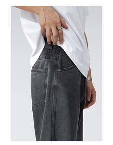 Detailed side view of dark grey straight-leg denim jeans with contrast stitching and pockets