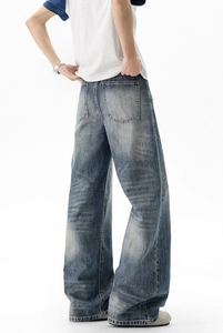 Macro shot showing retro washed texture and cat whiskers on the back of wide-leg jeans