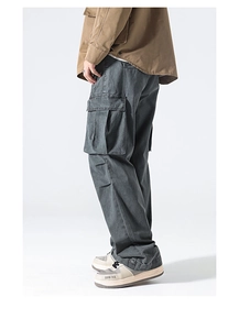 Detail view of washed dark grey cargo pants with side pockets and loose straight cut