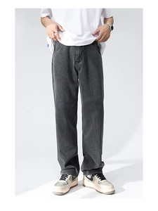Detail of dark gray wide-leg denim jeans showing washed texture and straight cut drape