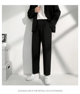 Détail du pantalon de costume noir pour homme avec plis centraux et coupe droite fluide