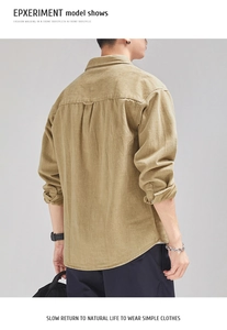 Detail of khaki textured cotton shirt back with horizontal stitching and center pleat