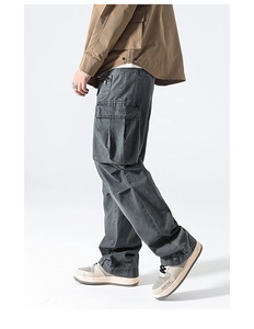 Detail view of washed gray multi-pocket cargo pants with durable cotton twill texture