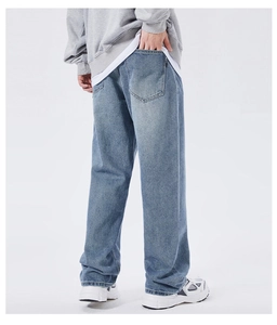 Back view of light blue washed baggy jeans with vintage fade and wide straight leg fit