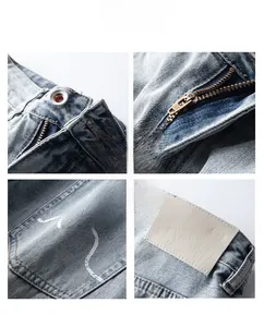 Détails du jean avec fermeture éclair YKK, bouton en métal et couture vague sur la poche