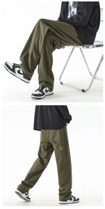 Detail der armee-grünen Wide-Leg Cargo-Hose mit großen Seitentaschen aus hochwertigem Twill-Baumwolle