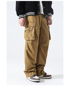 Detailed close-up of khaki cargo pants featuring large utility pockets and zip details