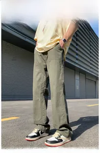 Detail of army green cargo pants featuring heavy cotton twill and utility stitching