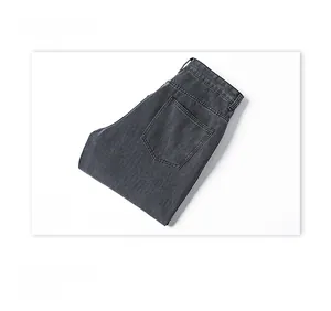 Detailed macro view of dark grey denim fabric texture and rear pocket stitching design