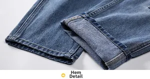 Detailed macro view of cuffed denim leg opening with precise yellow contrast stitching