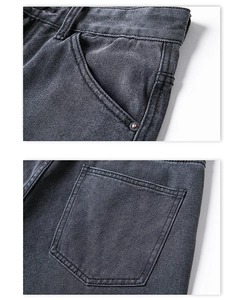 Close-up of deep gray denim jeans showing front pocket rivets and back pocket stitching