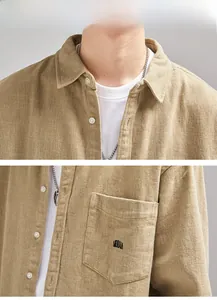 Detailed macro view of khaki corduroy shirt collar and chest pocket with black embroidery