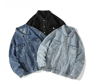 Close-up of three denim jackets in black, mid-blue, and light blue with washed texture
