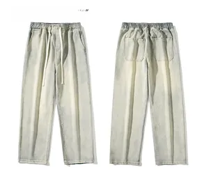 Détails de la taille élastique à cordon et texture du tissu délavé sur un jean large