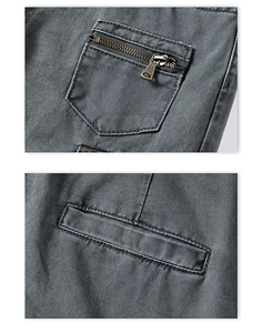 Detail showing vintage metal zipper pocket and fine stitching on dark grey cargo pants