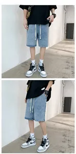 Close-up of light blue washed denim shorts with white drawstring and elastic waist