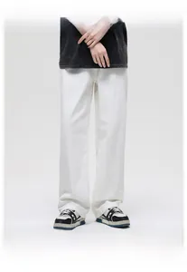 Minimalist men's white loose straight fit denim jeans styled with casual sneakers