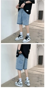 Front and back view of loose fit light blue washed denim shorts on a model