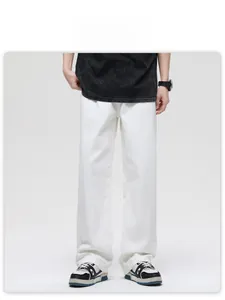 Detailed full-length shot of white high-waisted wide-leg cotton jeans for street style