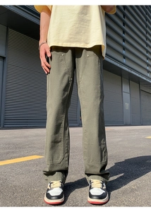 Detail of olive green double knee work pants with reinforced rivets and cotton canvas fabric