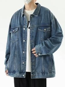Retro loose fit denim jacket in classic blue wash with symmetrical chest pockets and buttons