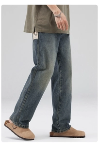 Detail of vintage washed straight jeans showing side textile label and denim texture