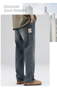 Detail of vintage blue wide-leg jeans with a branded fabric label on a city background