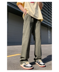 Outdoor shot of olive double knee work trousers with rivets and loose straight-leg fit