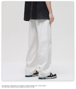 Detail view of white cotton denim wide-leg pants with classic rear patch pocket design