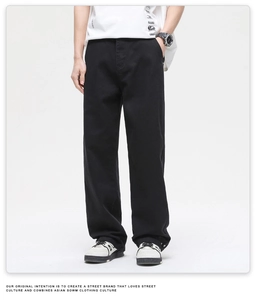 Detailed full-length view of men's white wide-leg cotton denim trousers with a clean drape