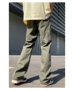 Rear view of olive green cargo pants with classic carpenter pockets in loose fit style