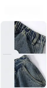 Detail view of elastic waistband and front pockets on classic blue denim jeans
