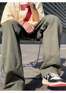 Detail view of olive green vintage cargo pants with reinforced double knee panels