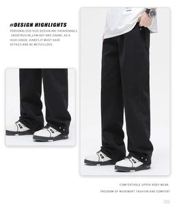 Detail view of black straight-leg trousers featuring metal snaps and side stitching accents