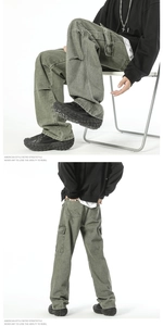 Detail view of American-style retro cargo pants with side pockets in washed olive green
