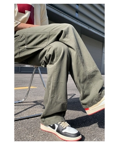 Detail shot of olive green cargo pants with reinforced knee panels and utility pockets