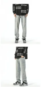 Detail of light blue vintage tapered jeans featuring back pocket embroidery and streetstyle fit
