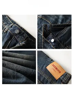 Detailed close-up of dark blue denim jeans waist with metal button and leather brand tag