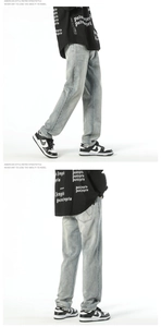 Detail of light blue straight denim jeans with vintage wash effect and loose fit
