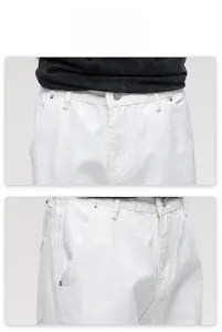 Detail view of white cotton denim waist with metal button and reinforced rivet pockets