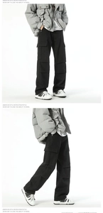 Detailed side view of black wide-leg cargo pants with large functional utility pockets