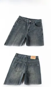 Detail view of retro washed blue jeans with vintage texture and leather waist patch